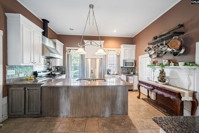 131 Pine St, Salley, SC 29137 - kitchen featuring a peninsula, white cabinets, a sink, stainless steel appliances, and decorative backsplash