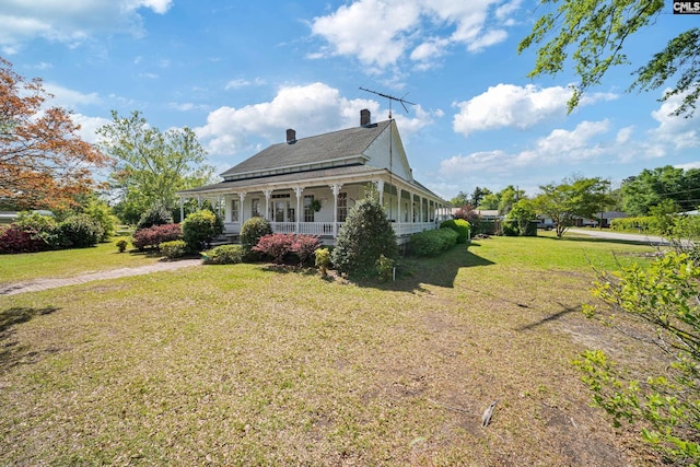 131 Pine St, Salley, SC 29137 - back of property featuring a porch, a shingled roof, a lawn, and a chimney