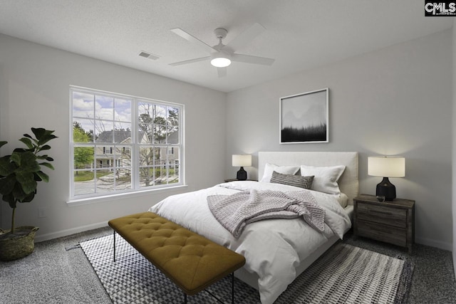 carpeted bedroom featuring visible vents, baseboards, and ceiling fan