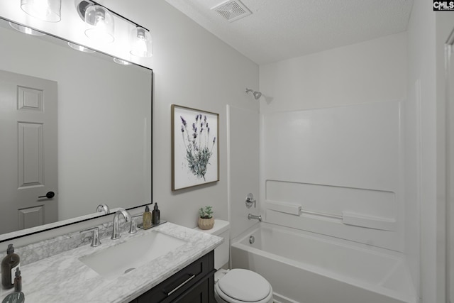 full bath featuring visible vents, washtub / shower combination, toilet, a textured ceiling, and vanity