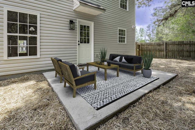view of patio / terrace featuring an outdoor living space and fence