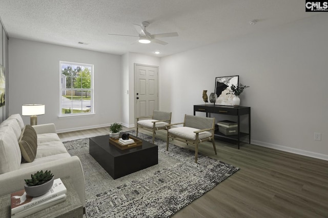living area featuring visible vents, baseboards, a ceiling fan, and wood finished floors