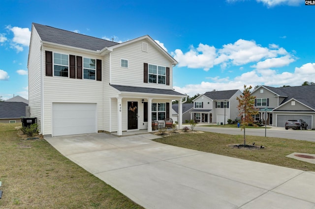 traditional-style home featuring concrete driveway, a residential view, a front lawn, a porch, and a garage