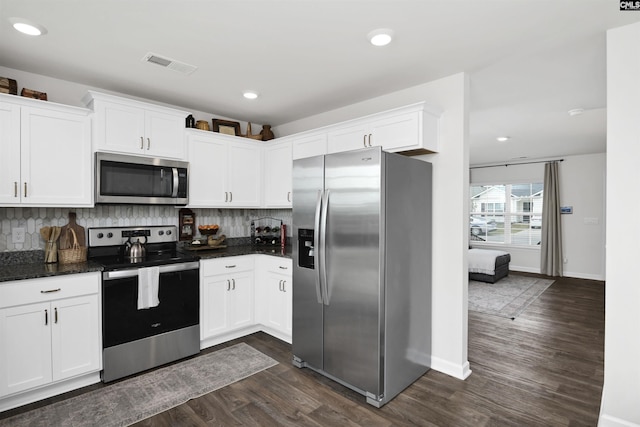 kitchen featuring white cabinets, dark wood-style floors, visible vents, and stainless steel appliances