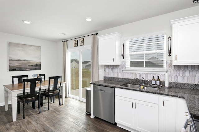 kitchen featuring stainless steel dishwasher, tasteful backsplash, white cabinetry, a sink, and dark wood-style floors