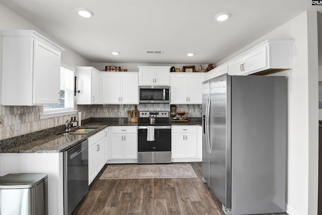 kitchen featuring visible vents, white cabinets, a sink, dark wood-style flooring, and appliances with stainless steel finishes