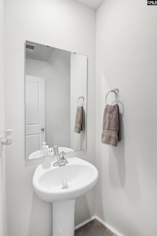 bathroom with baseboards and visible vents