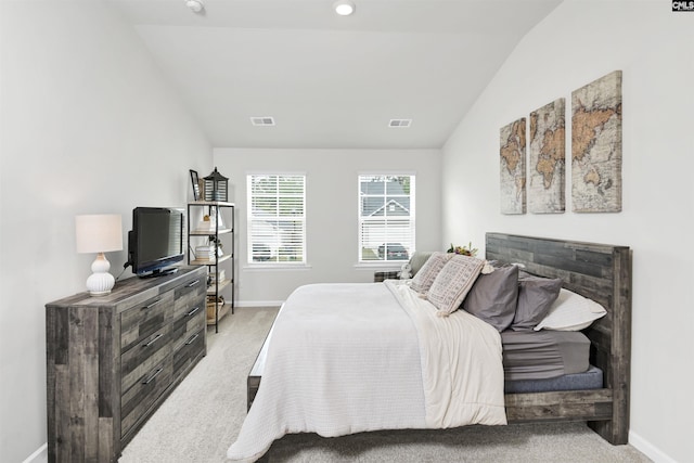 bedroom with carpet flooring, visible vents, baseboards, and lofted ceiling