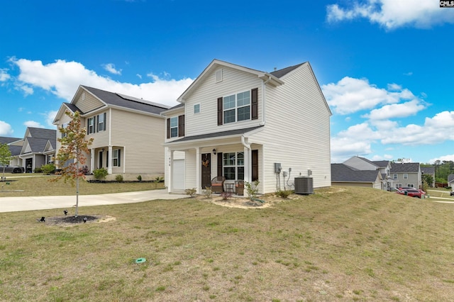 traditional home with an attached garage, a residential view, driveway, and a front lawn