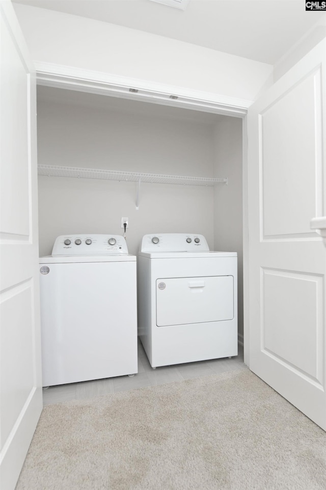 laundry room with washer and dryer and laundry area