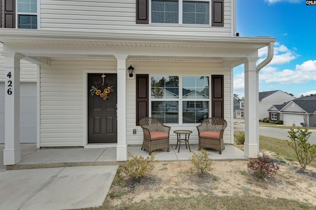 view of exterior entry with a porch