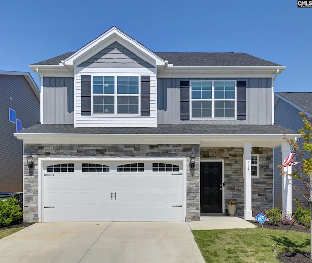 craftsman-style home featuring an attached garage, board and batten siding, concrete driveway, and stone siding
