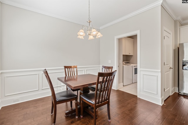 126 Sunset Bay Ln, Lexington, SC 29072 - dining area with ornamental molding, a chandelier, independent washer and dryer, a decorative wall, and wood-type flooring