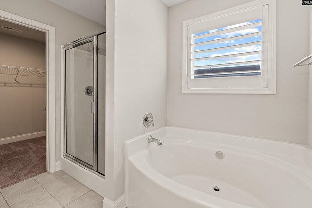 126 Sunset Bay Ln, Lexington, SC 29072 - full bathroom featuring a garden tub, a shower stall, a spacious closet, visible vents, and tile patterned floors