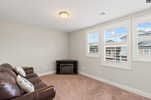 126 Sunset Bay Ln, Lexington, SC 29072 - living area with a glass covered fireplace, visible vents, baseboards, and carpet floors