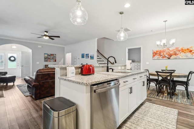 kitchen with stainless steel dishwasher, dark wood-style floors, a sink, open floor plan, and ceiling fan with notable chandelier