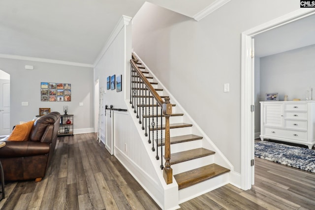 staircase with ornamental molding, baseboards, arched walkways, and wood finished floors