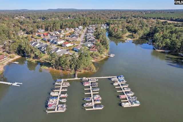 aerial view with a forest view and a water view
