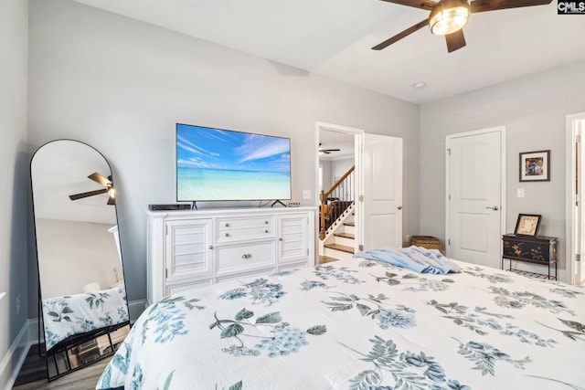 bedroom with baseboards, a ceiling fan, and wood finished floors
