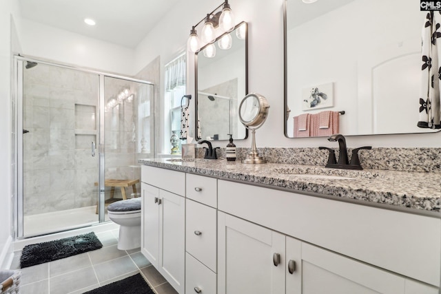bathroom featuring a sink, a shower stall, and toilet