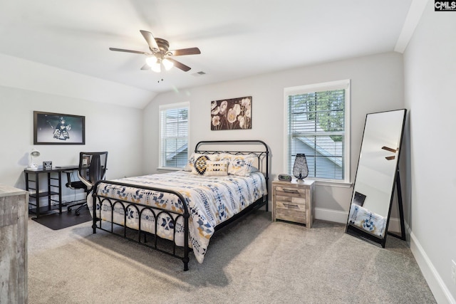 carpeted bedroom featuring visible vents, baseboards, a ceiling fan, and vaulted ceiling