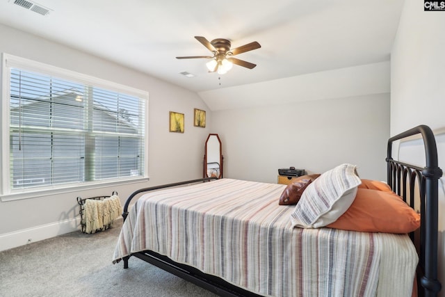 carpeted bedroom featuring visible vents, baseboards, a ceiling fan, and lofted ceiling