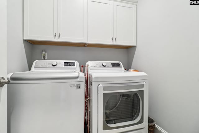 laundry room with separate washer and dryer and cabinet space