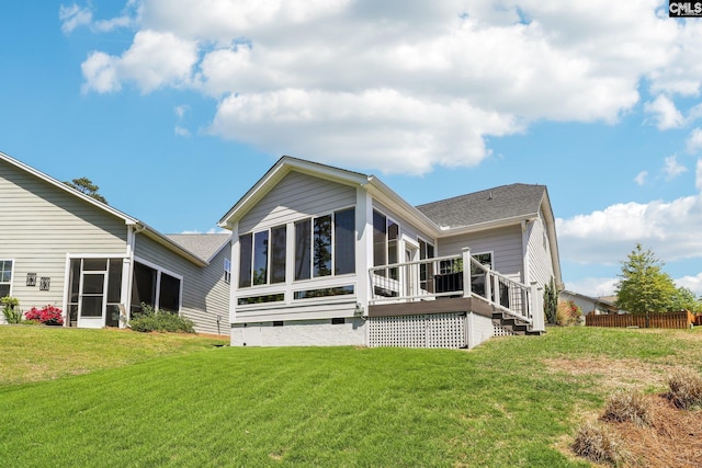 back of house featuring a yard, a sunroom, crawl space, and stairs