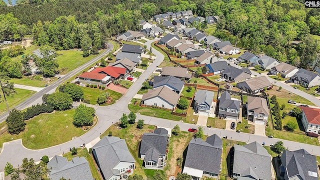 bird's eye view featuring a residential view and a wooded view