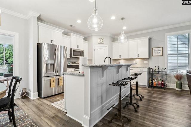 kitchen featuring tasteful backsplash, visible vents, ornamental molding, appliances with stainless steel finishes, and dark wood-type flooring
