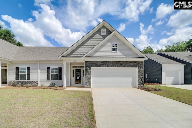 craftsman-style house with an attached garage, driveway, stone siding, and a front lawn