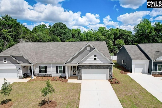 view of front of home with a front yard, stone siding, and an attached garage