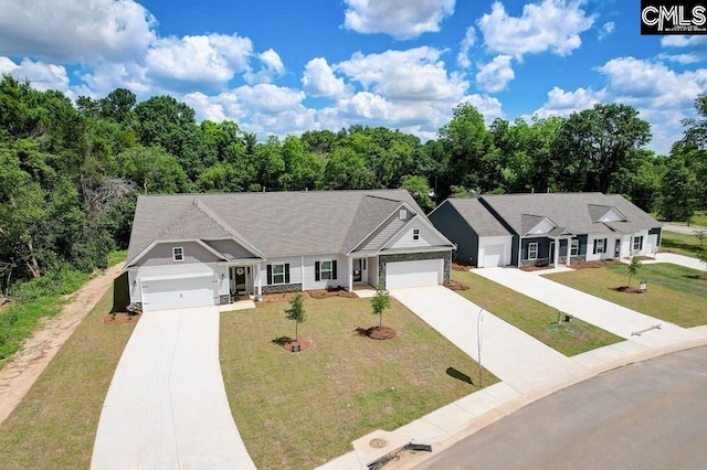 view of front of house with an attached garage, driveway, and a front yard