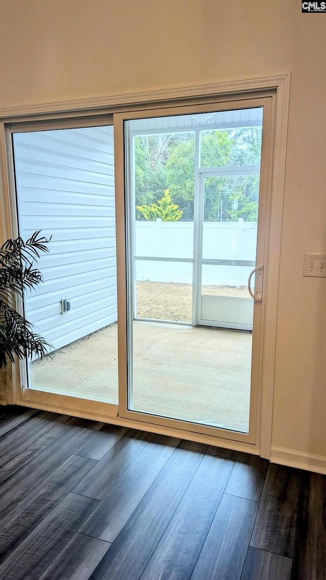 doorway to outside with dark wood-type flooring and a wealth of natural light
