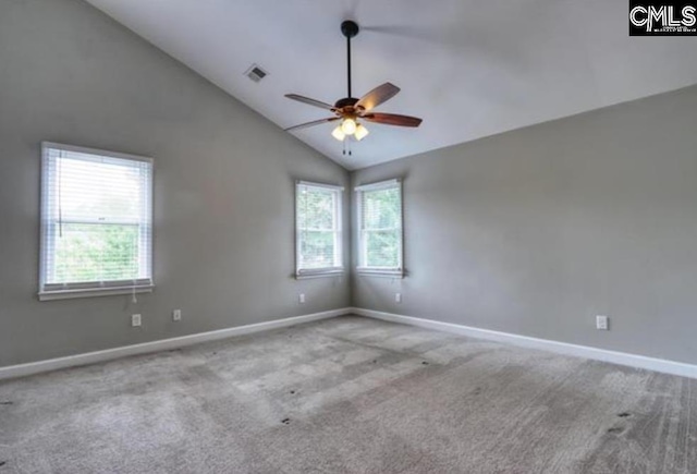 carpeted spare room featuring ceiling fan, baseboards, and lofted ceiling