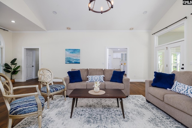 1168 Peninsula Dr, Prosperity, SC 29127 - living area with vaulted ceiling, wood finished floors, an inviting chandelier, baseboards, and ornamental molding