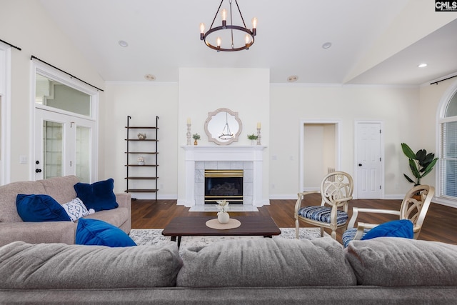 1168 Peninsula Dr, Prosperity, SC 29127 - living room featuring lofted ceiling, a tile fireplace, wood finished floors, and a notable chandelier