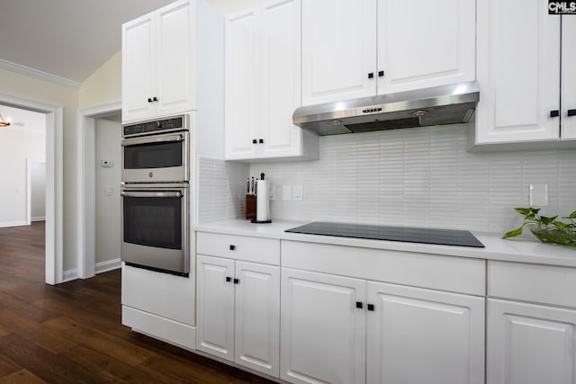 1168 Peninsula Dr, Prosperity, SC 29127 - kitchen featuring black electric cooktop, stainless steel double oven, under cabinet range hood, light countertops, and ornamental molding