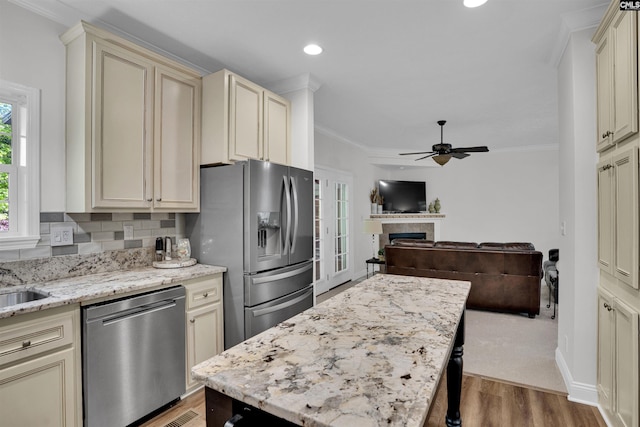107 Turkey Ridge Ln, Lugoff, SC 29078 - kitchen featuring ornamental molding, a ceiling fan, cream cabinetry, and stainless steel appliances