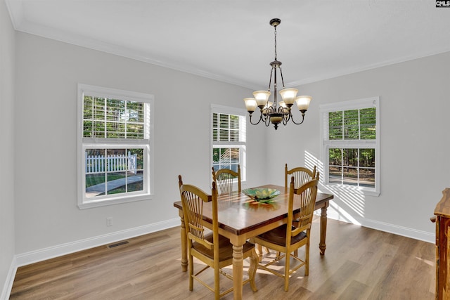 107 Turkey Ridge Ln, Lugoff, SC 29078 - dining area with a healthy amount of sunlight, crown molding, and an inviting chandelier