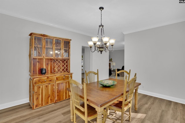 107 Turkey Ridge Ln, Lugoff, SC 29078 - dining area with baseboards, ornamental molding, an inviting chandelier, and light wood-type flooring