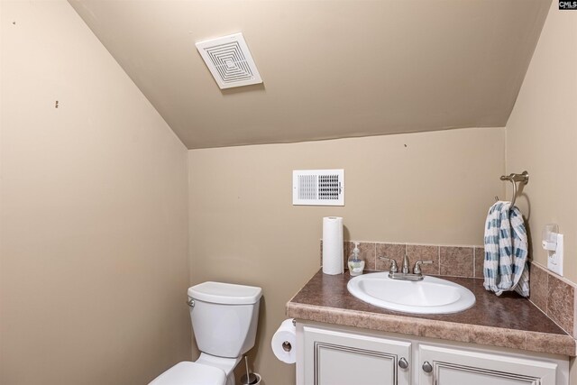 107 Turkey Ridge Ln, Lugoff, SC 29078 - bathroom with lofted ceiling, visible vents, vanity, and toilet