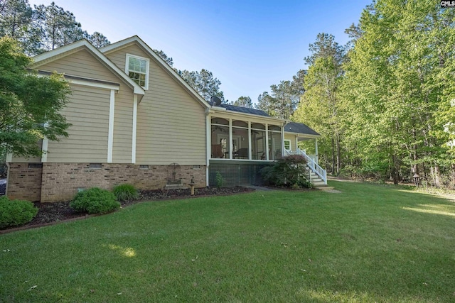 107 Turkey Ridge Ln, Lugoff, SC 29078 - view of home's exterior featuring a lawn, a sunroom, roof with shingles, and crawl space