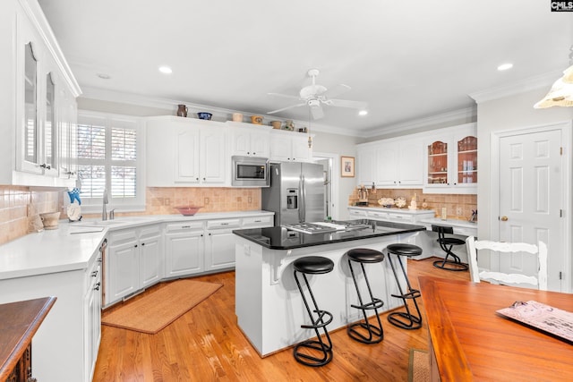 411 Turkey Point Cir, Columbia, SC 29223 - kitchen with backsplash, a ceiling fan, a sink, appliances with stainless steel finishes, and a breakfast bar area