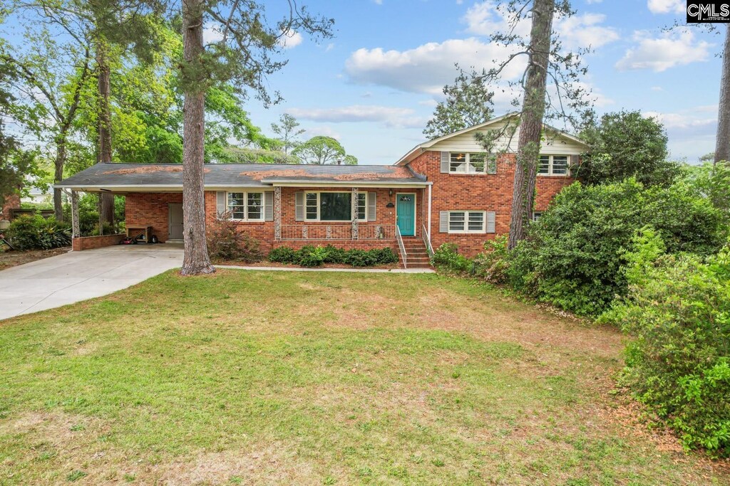 3803 Rockbridge Rd, Columbia, SC 29206 - tri-level home featuring brick siding, driveway, a front yard, and a carport