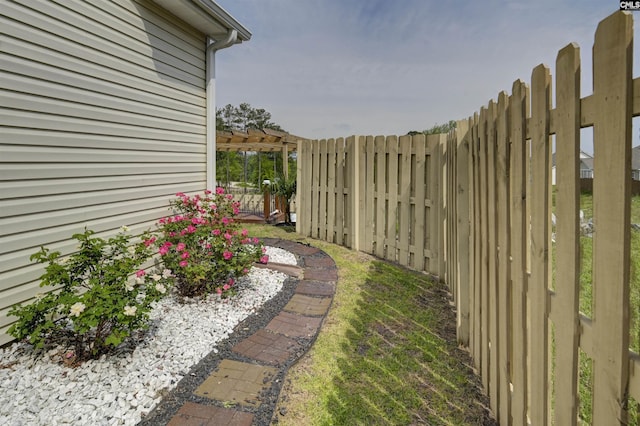 view of yard featuring fence and a pergola