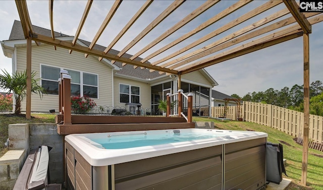 exterior space with a sunroom, a hot tub, and fence