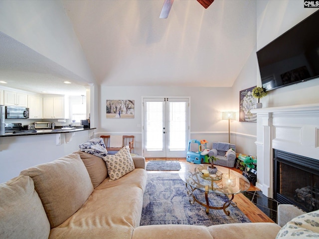 78 Southern Oak Dr, Camden, SC 29020 - living area with lofted ceiling, french doors, a wealth of natural light, and a fireplace with flush hearth