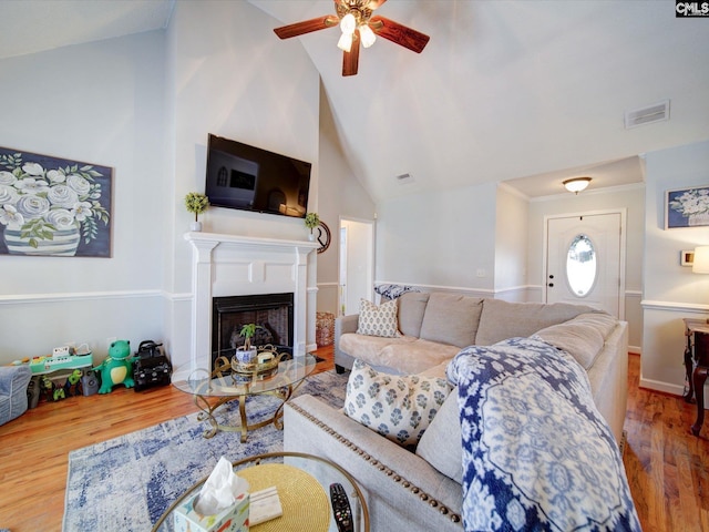 78 Southern Oak Dr, Camden, SC 29020 - living room featuring vaulted ceiling, visible vents, a ceiling fan, wood finished floors, and a fireplace
