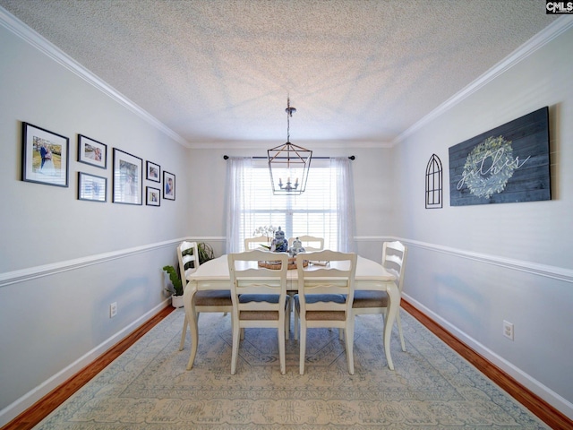 78 Southern Oak Dr, Camden, SC 29020 - dining space with an inviting chandelier, ornamental molding, wood finished floors, and a textured ceiling